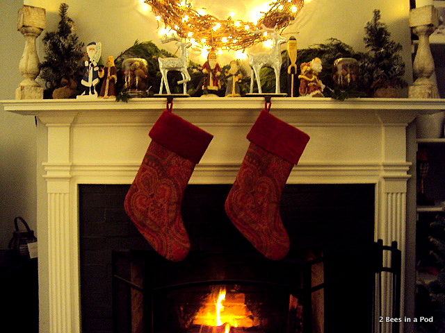 Stockings from Pottery Barn, hand painted Santa's, greenery, burlap, grape vine wreath, lit fireplace, Christmas Mantle