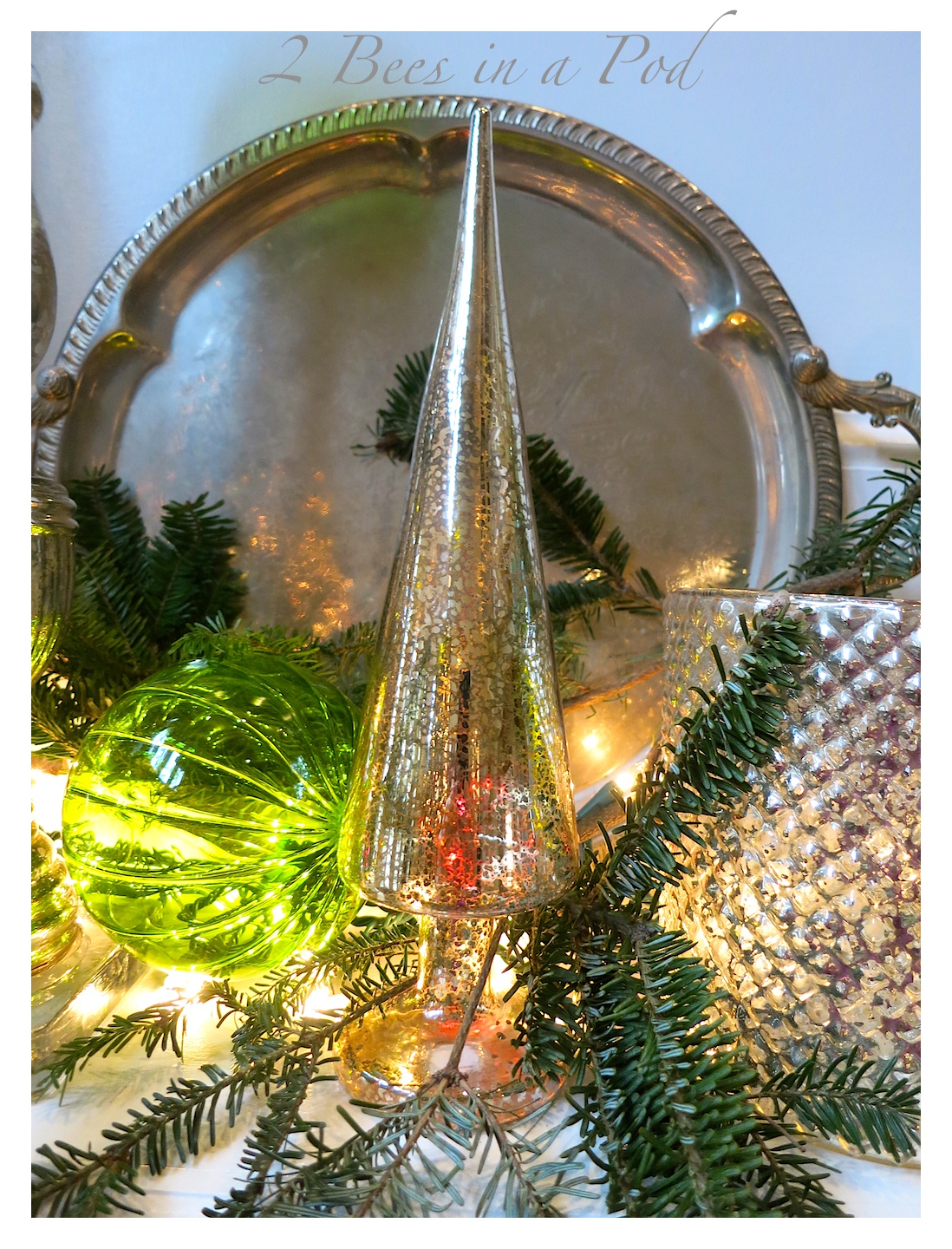 Traditional Christmas mantle decor using Mercury glass, green and red. I also used vintage silver trays as a backdrop.