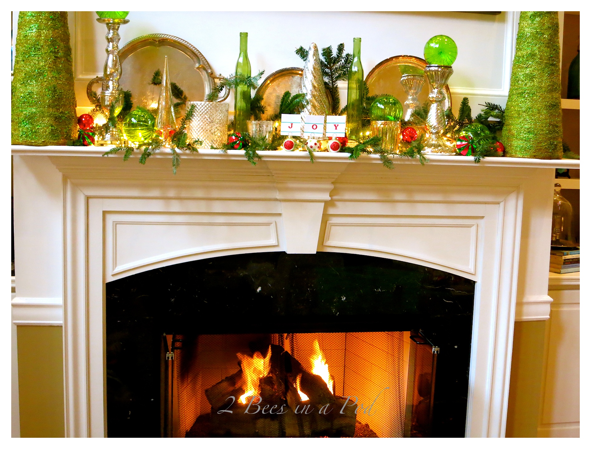 Traditional Christmas mantle decor using Mercury glass, green and red. I also used vintage silver trays as a backdrop.