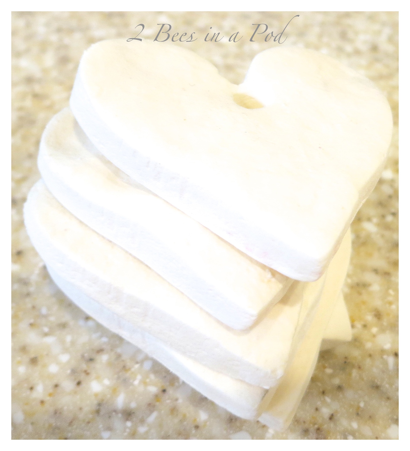 Homemade white clay gift tags for Valentines Day. Very easy to make clay using baking soda, corn starch and water. Use any cookie cutters or cutouts. Bake in the oven and the dough hardens. Very cute!!