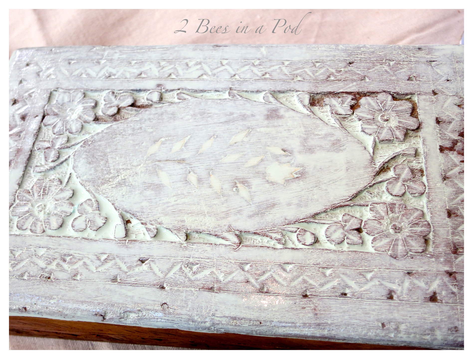 A sage gray paint-wash finish really brought out the beautiful carved details on this vintage wood box. Topped with a thin layer of paste wax and it is a beautiful display box. Makeover transformation is complete!