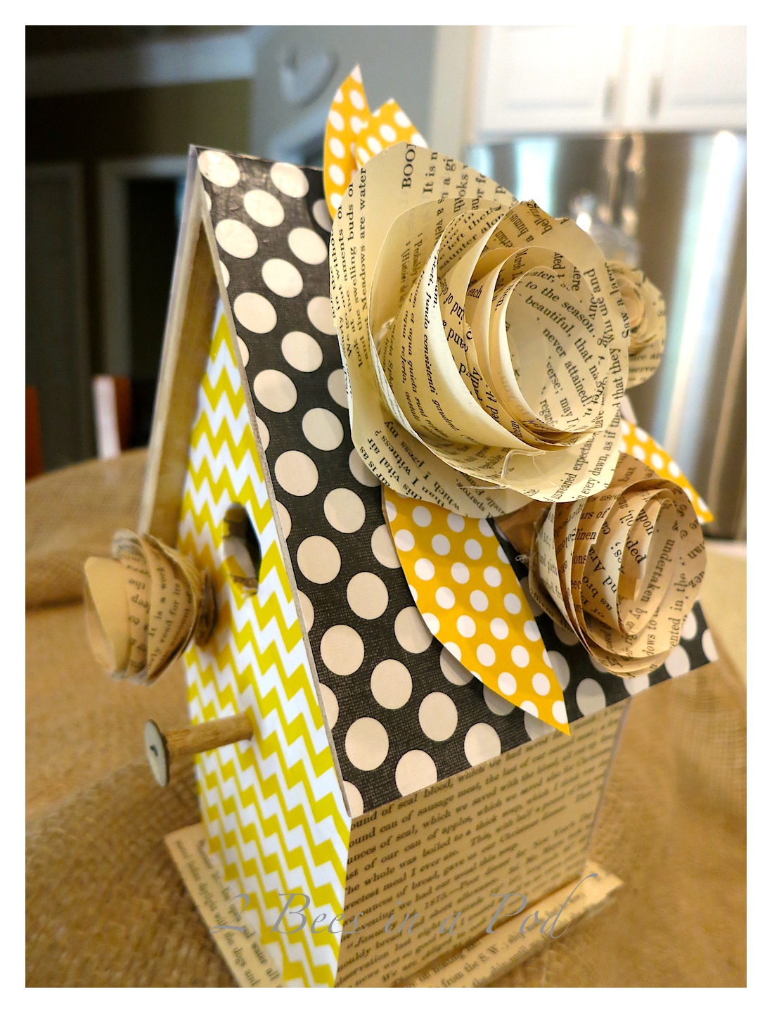Create a decorative birdhouse. we usedd Mod Podge. scrapbook paper, antique book pages and a pre made birdhouse. For added decoration we made flowers from the antique book pages.