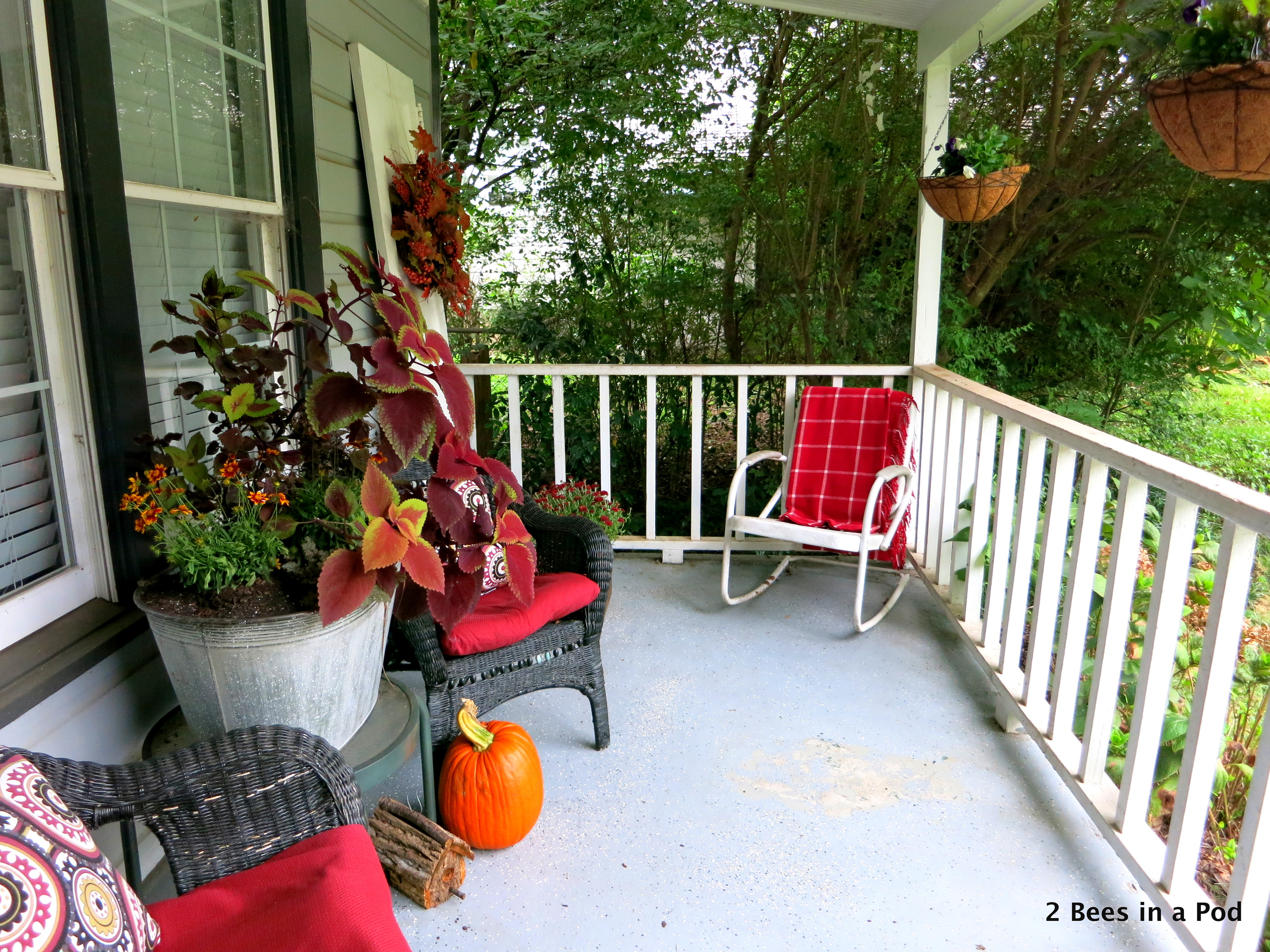 Fall Front Porch decor with mums, pumpkins, galvanized planter, hanging baskets, kale, wreath, vintage door, rustic birdhouse