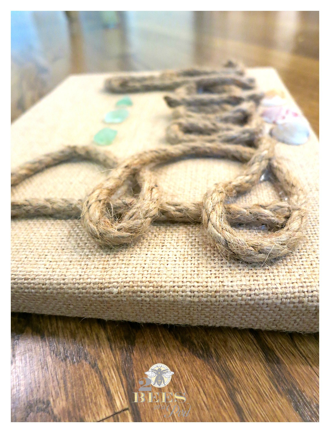 DIY Burlap Canvas Beach Art. Super simple artwork - add jute or rope to spell out "Beach" and embellish with shells and sea glass!