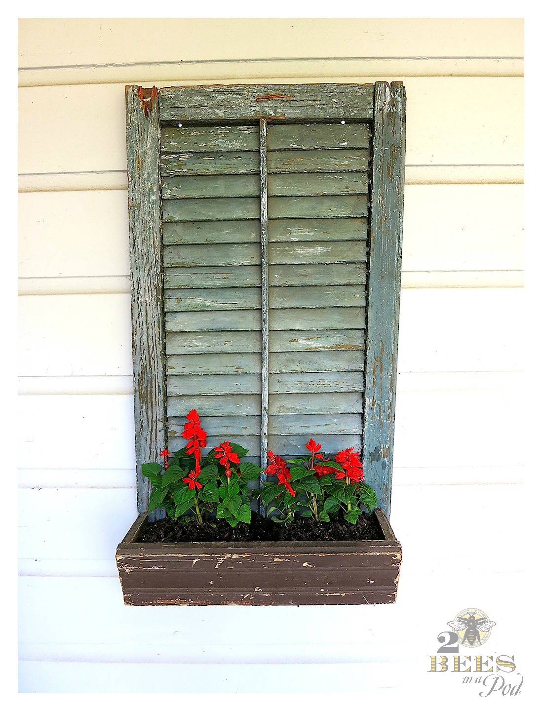 Front Porch Refresh makeover using an outdoor rug, vintage finds and new flowers.