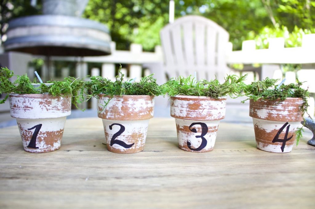 Citronella Candles in Mini Clay Pots. French script numbers on mini clay pots.