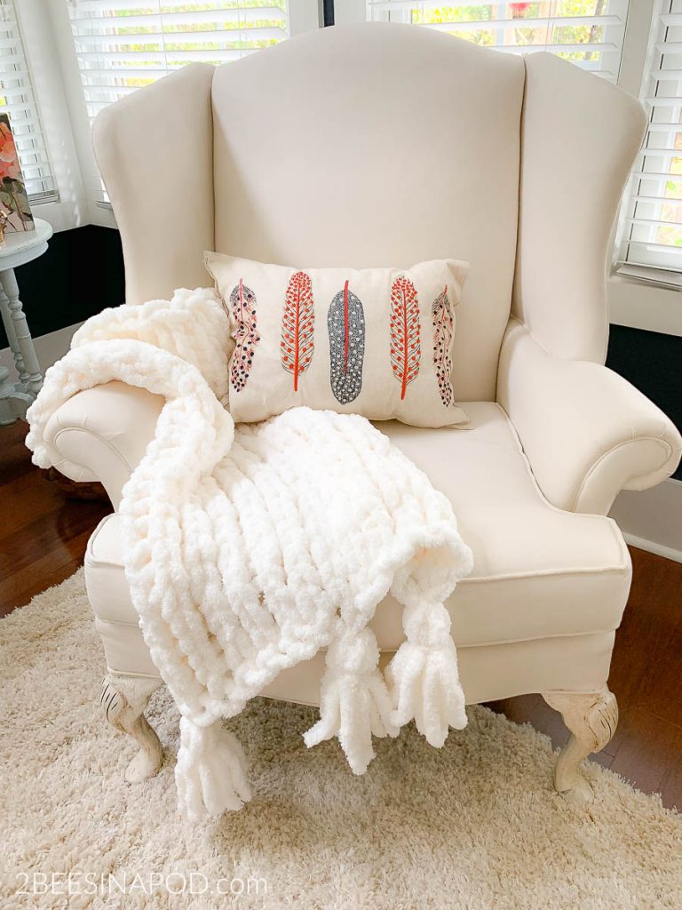 The handmade chunky throw looks perfect on the painted wing chair
